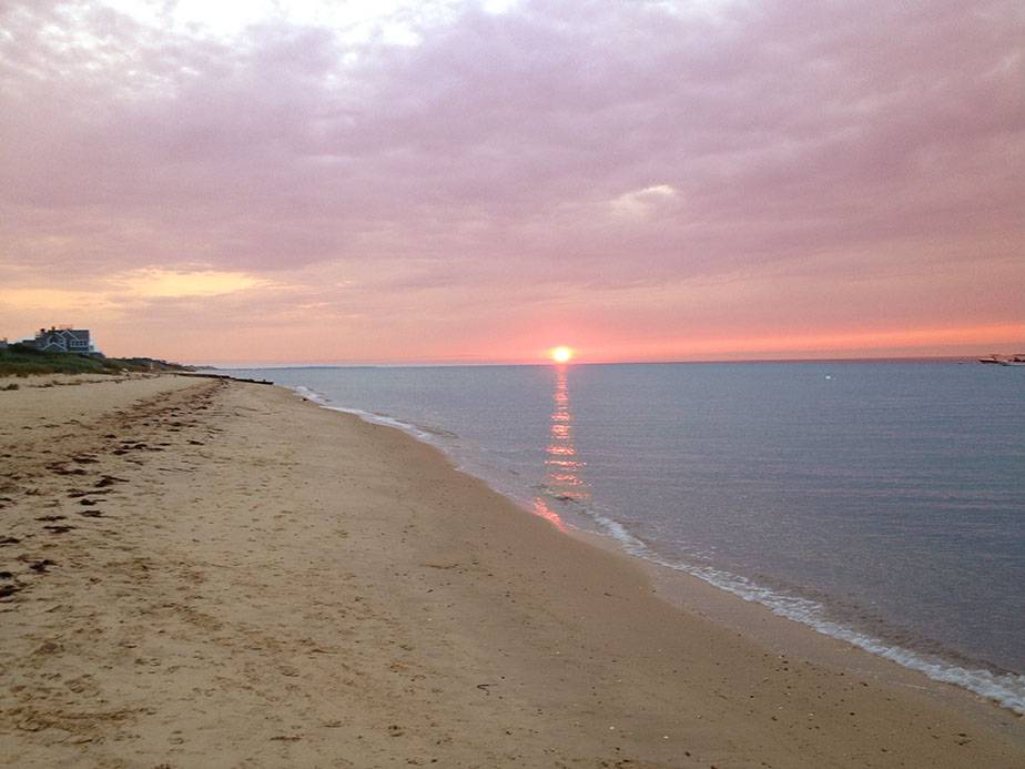 Golden sunset over the calm North Shore waters at Cliff Beach in Nantucket